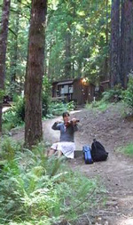 2006 camper practicing her fiddle along the forest path