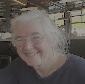 Mary Luckhardt smiling in a blue patterned scarf
